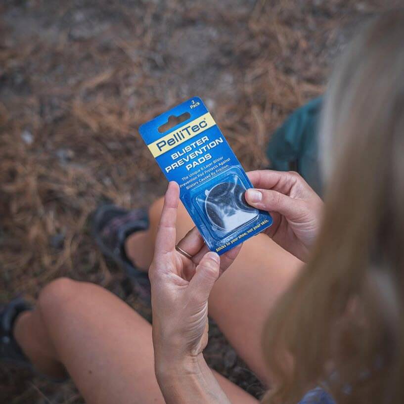 PelliTec Blister Prevention Pads - hiker holding package on the trail