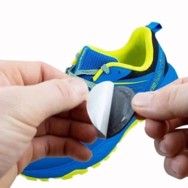PelliTec Blister Prevention Pads - runner applying pad to a running shoe